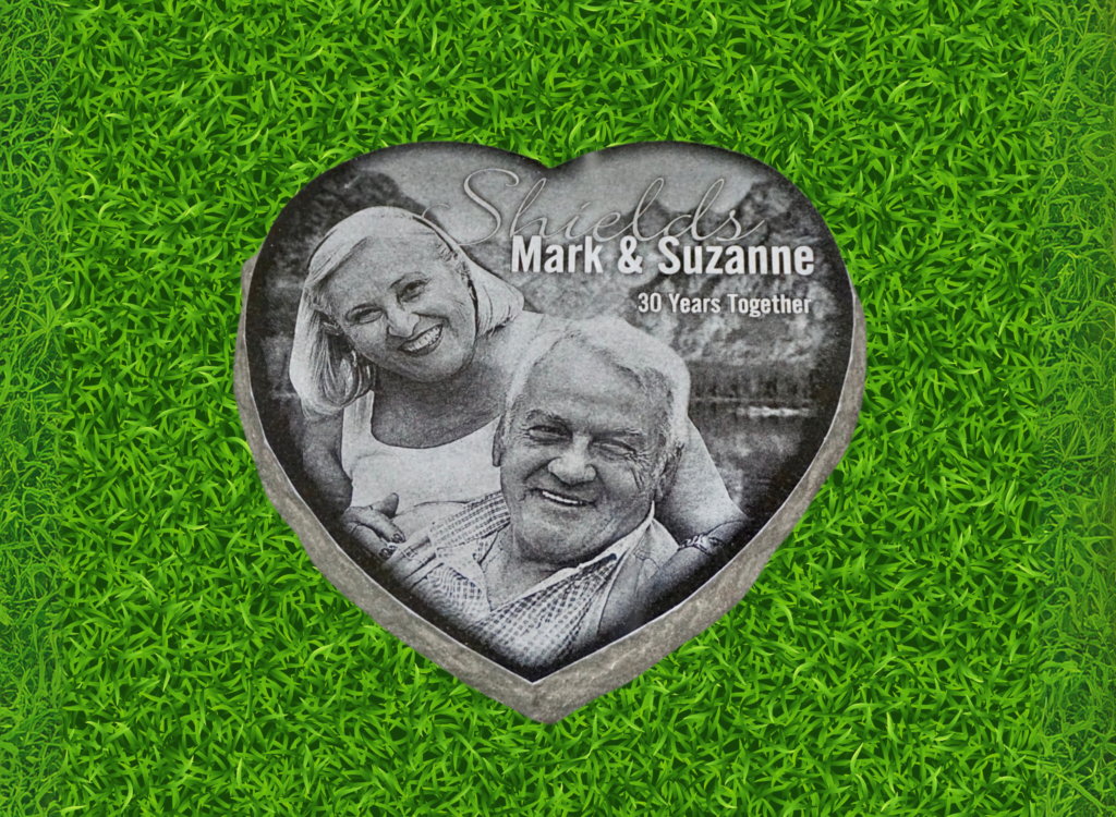 Heart shaped black granite memorial marker laser engraved with high resolution photo and love message.