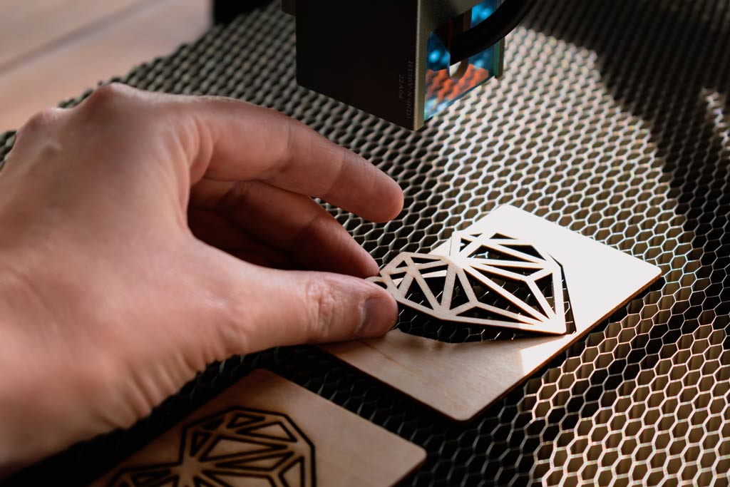 A hand holding an item that has been laser engraved