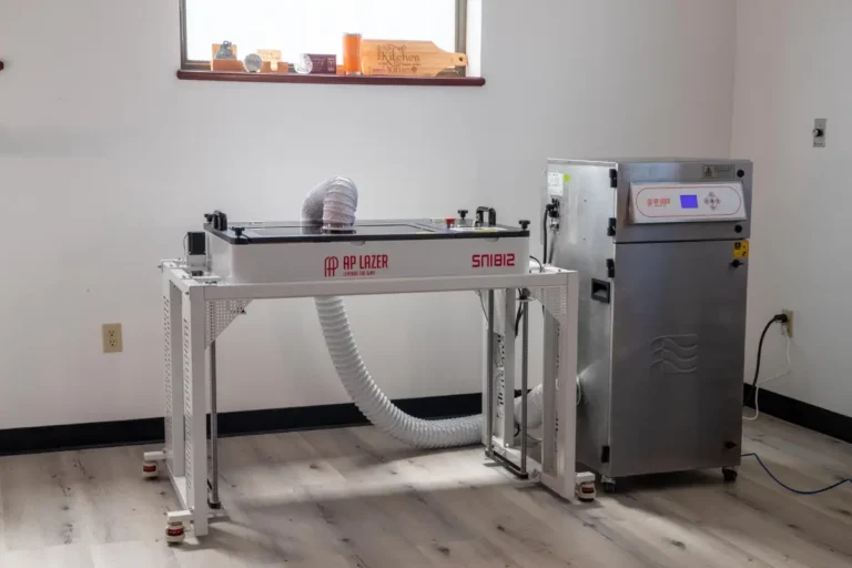 Laser engraving machine setup in a clean, modern room.